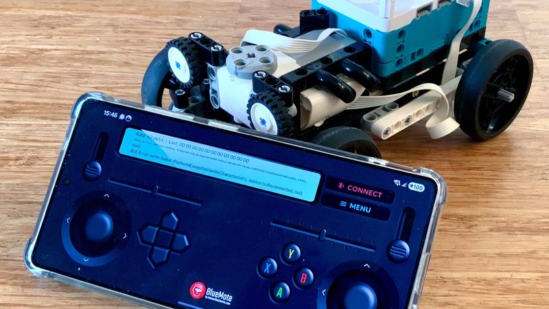 BlueMote gamepad next to a SPIKE Prime rover