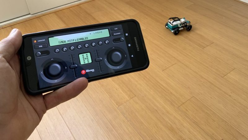 Phone in hand controlling a Robot Inventor car