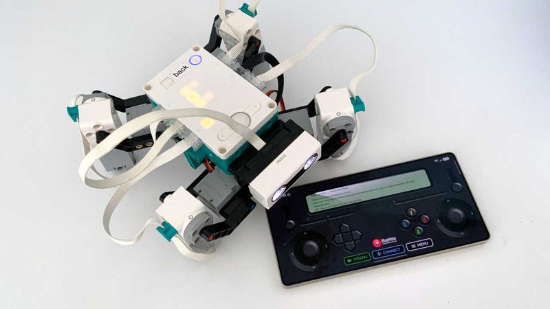 Servo spider beside a phone running BlueMote